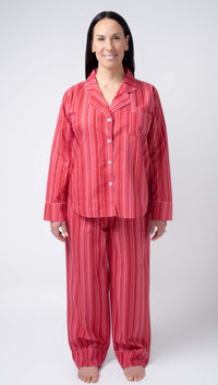 Woman wearing red striped pajamas on a white background